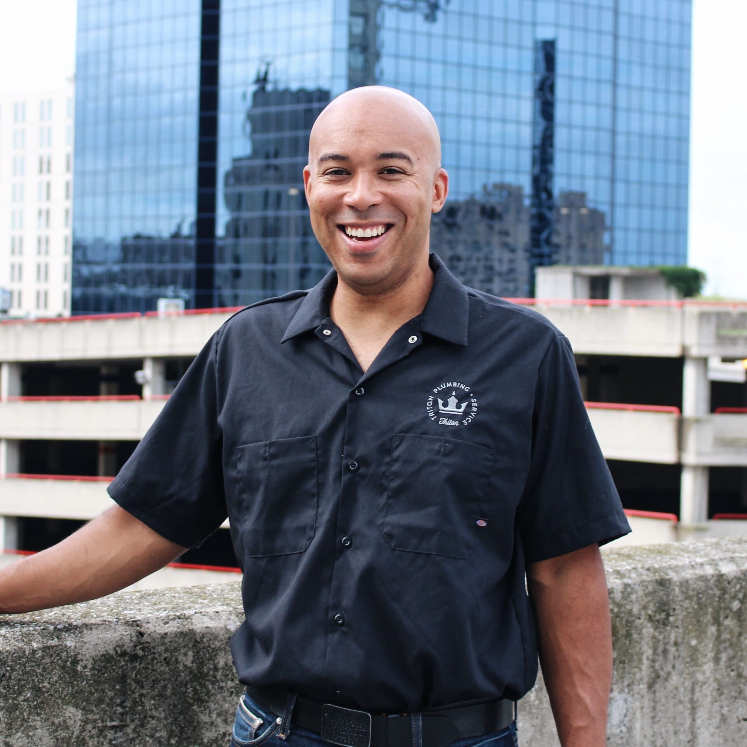 Aron Oretan, Red Seal plumber, steamfitter, and owner of Triton Home Services, standing in downtown London, Ontario.