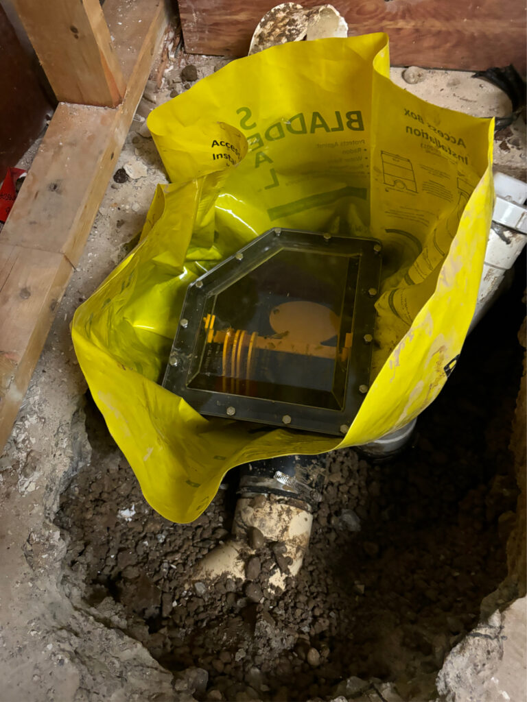 Triton Home Service licensed plumber installing backwater valve on sanitary sewer main in London Ontario home