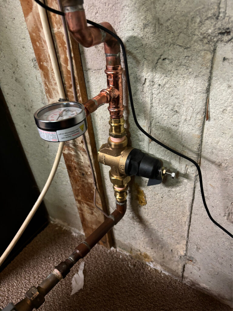 Triton Home Service licensed plumber installing pressure reducing valve station in London Ontario home