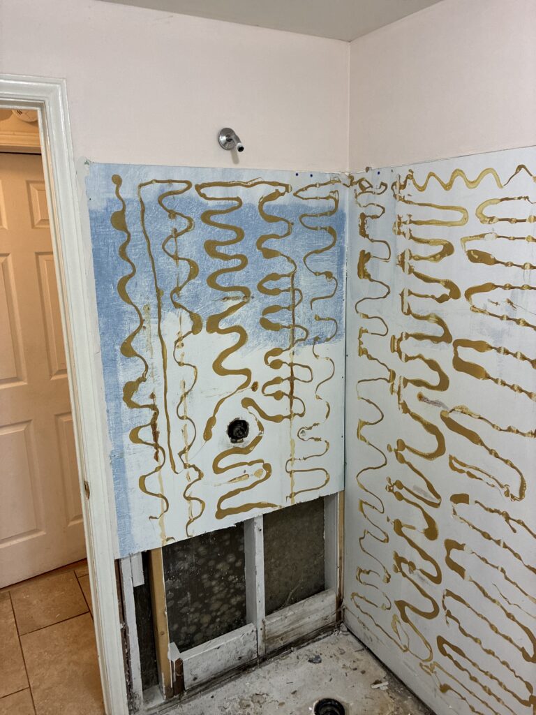 Exposed bathroom wall studs after removing an old neo-angle shower enclosure prior to a customer-supplied kit installation in St. Thomas, Ontario.