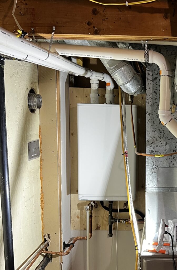 Wall-mounted IBC tankless water heater installed with proper venting and copper plumbing in a Westminster, London, Ontario home.