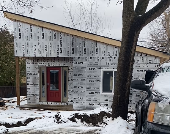 Backyard ADU plumbing installation with water and drain line trench, London Ontario